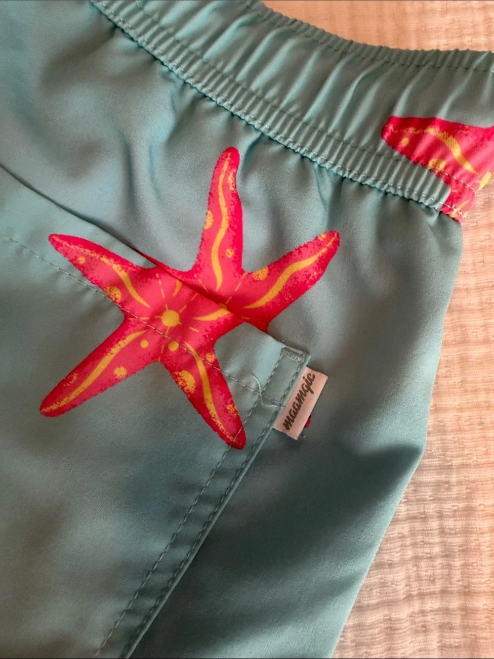 Kids Teal Swim Trunks with Pink Starfish Print